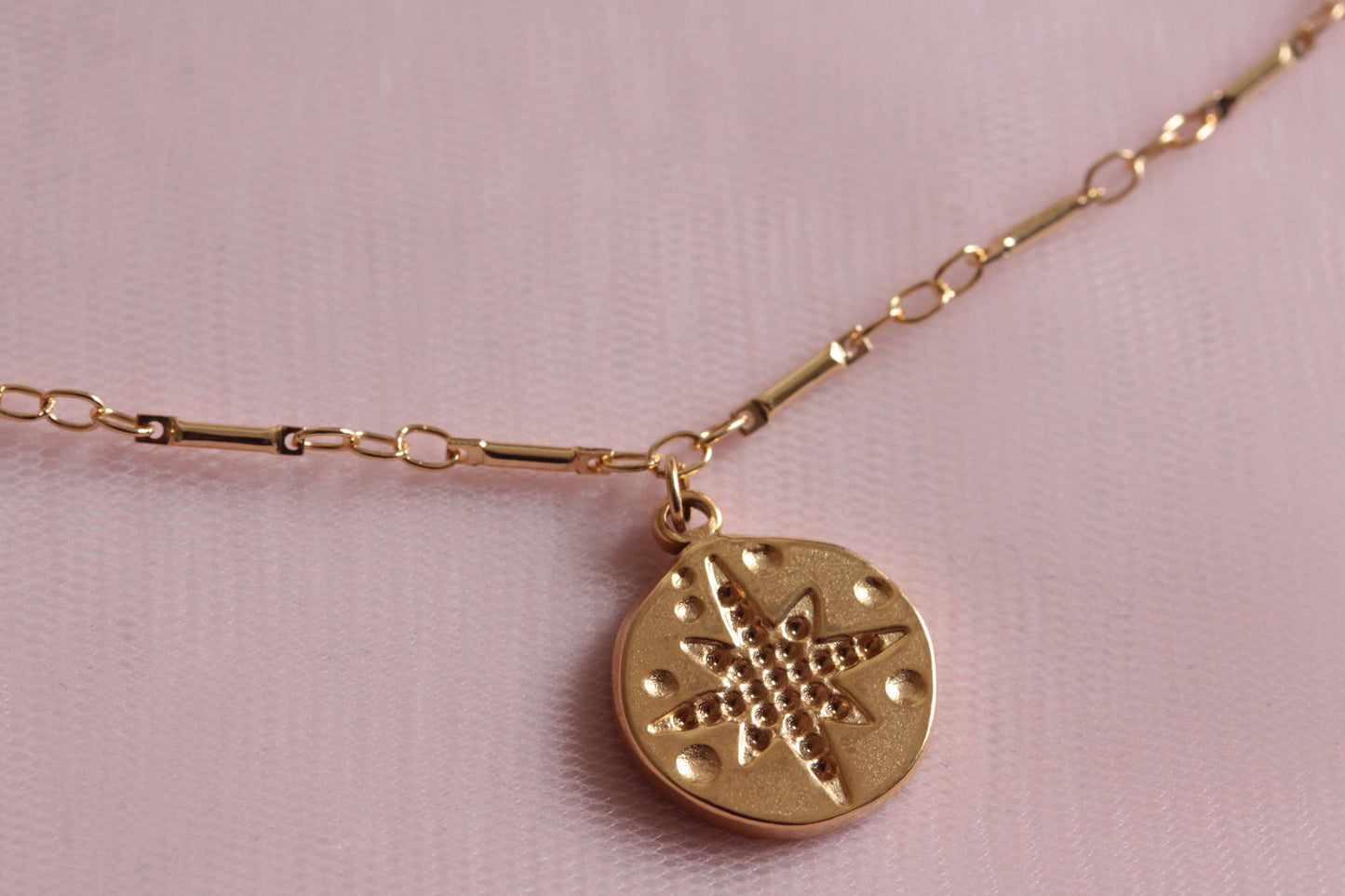 Collier doré avec médaille rose des vents